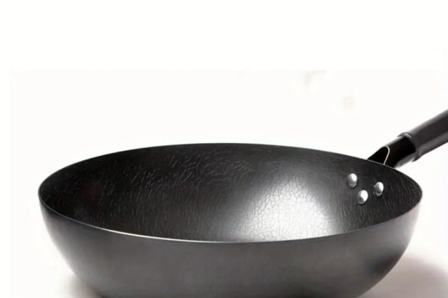 carbon steel wok on electric stove