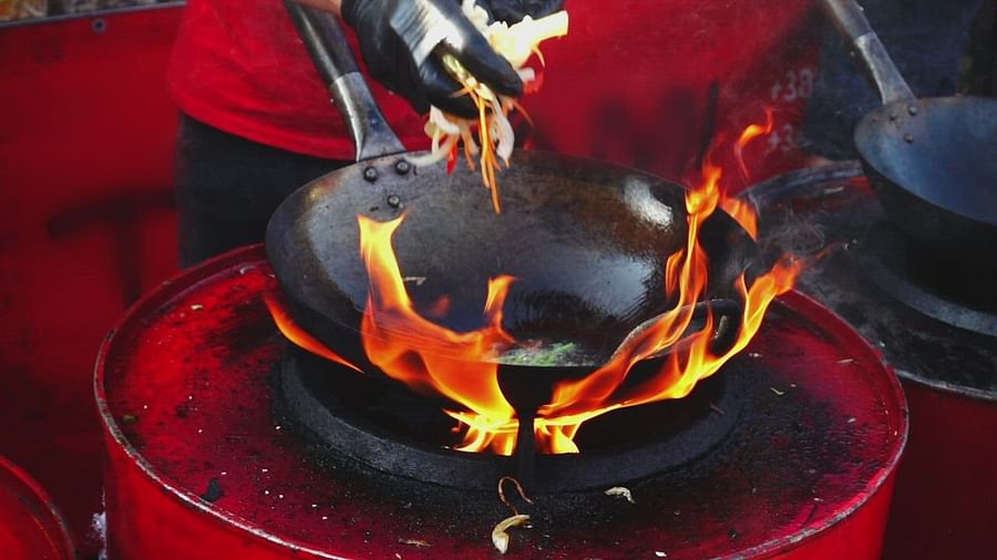 Wok on high flame showcasing Asian cooking techniques